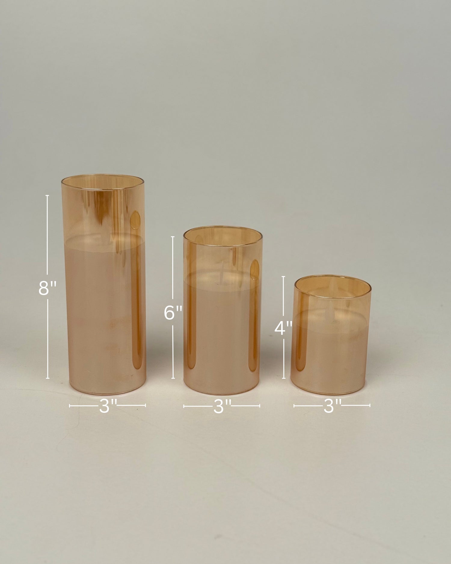 High Objects Lumiglass LED Candle Collection in amber glass cylinders, set of 3 sizes: 8", 6", and 4" tall.