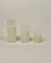 High Objects Lumiglass LED Candle Collection: set of 3 cream pillar candles in glass cylinders, 8", 6", 4" tall.