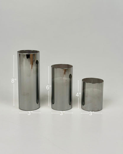 High Objects Lumiglass LED Candle Collection, set of 3 silver metallic pillar candles in glass cylinders, 8", 6", and 4" tall.