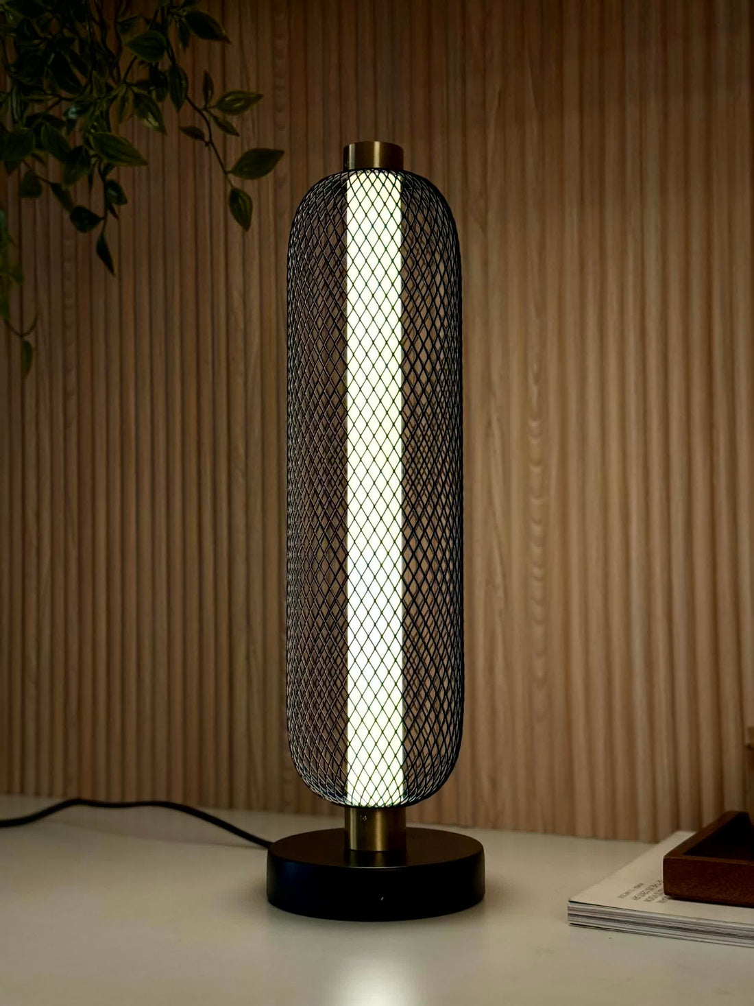 High Objects Lumina Mesh Column Table Lamp with black mesh shade, gold accents, and matte black base. Modern sculptural lighting.