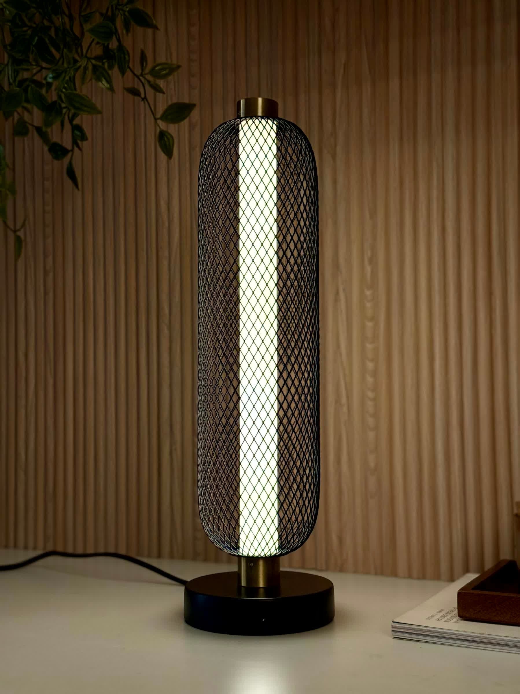High Objects Lumina Mesh Column Table Lamp with black mesh shade, gold accents, and matte black base. Modern sculptural lighting.