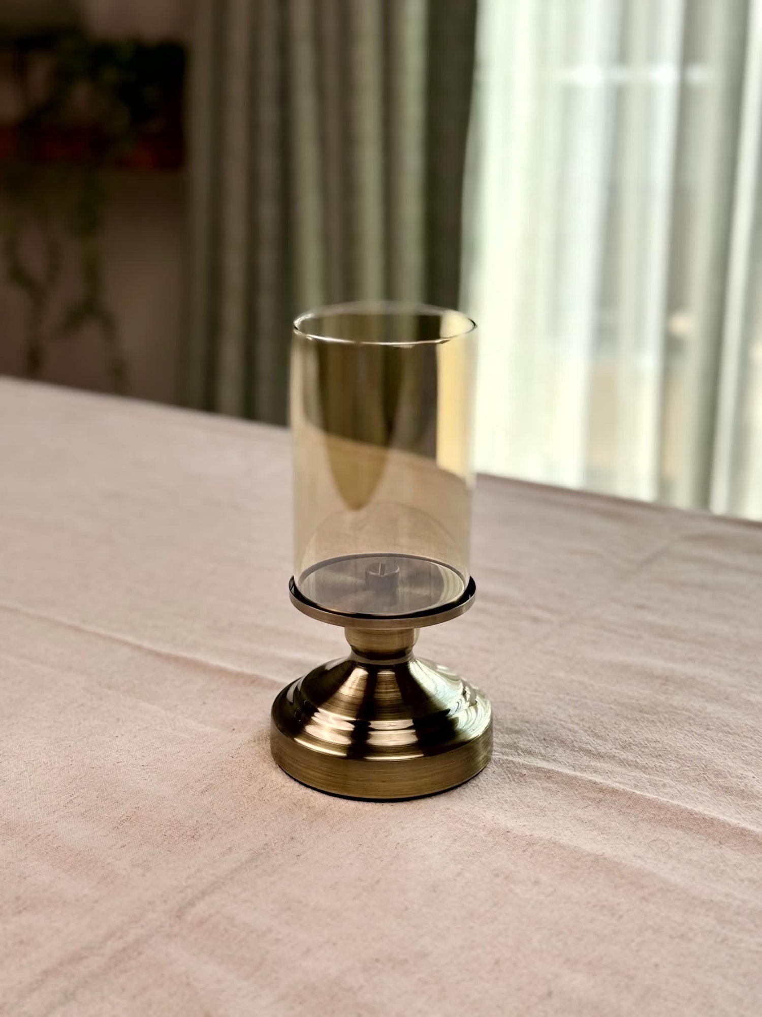 High Objects Luminaria Pedestal Candle Stand Set with tinted glass hurricane and metallic stem. Amber glass.