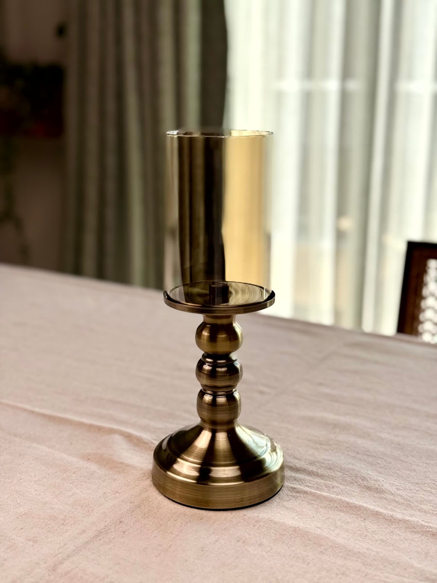 High Objects Luminaria Pedestal Candle Stand Set, antique brass metal base with stacked spheres, clear glass hurricane holder.