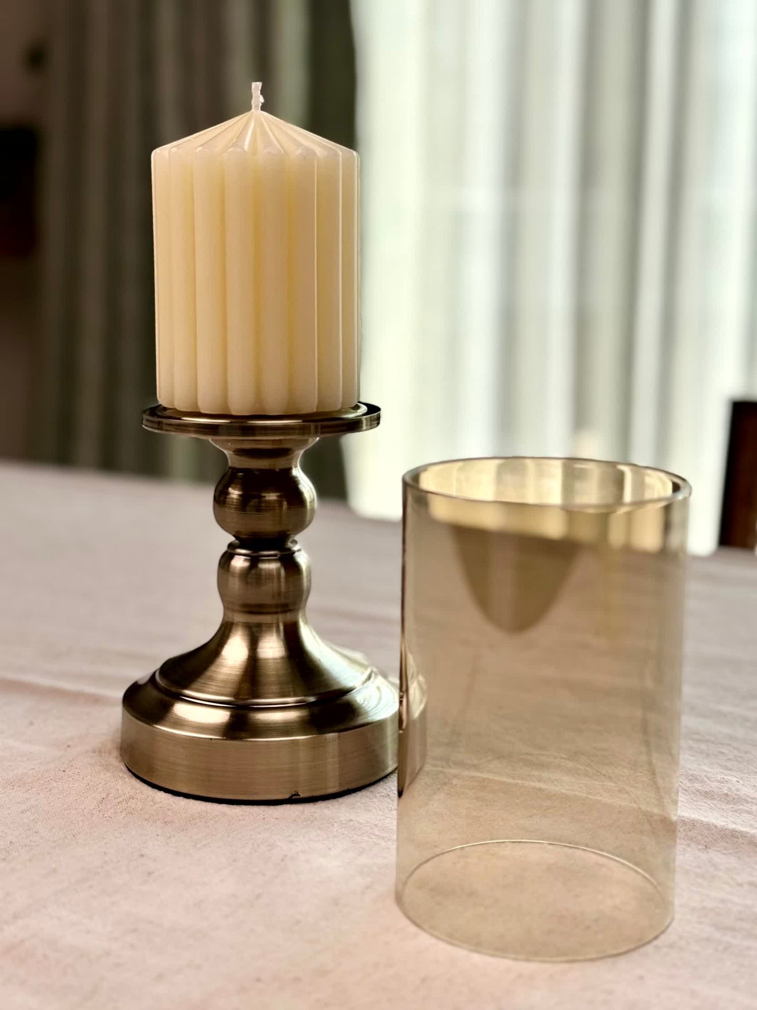 High Objects Luminaria Pedestal Candle Stand Set with cream pillar candle and tinted glass hurricane holder.