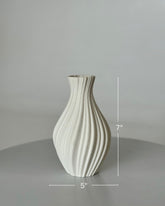 High Objects Lunara Vase, a 7-inch tall white ceramic vase with a ribbed, flowing pattern and a matte finish.