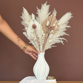 High Objects Lunara Vase, white ceramic with ribbed pattern, holding dried floral arrangement.