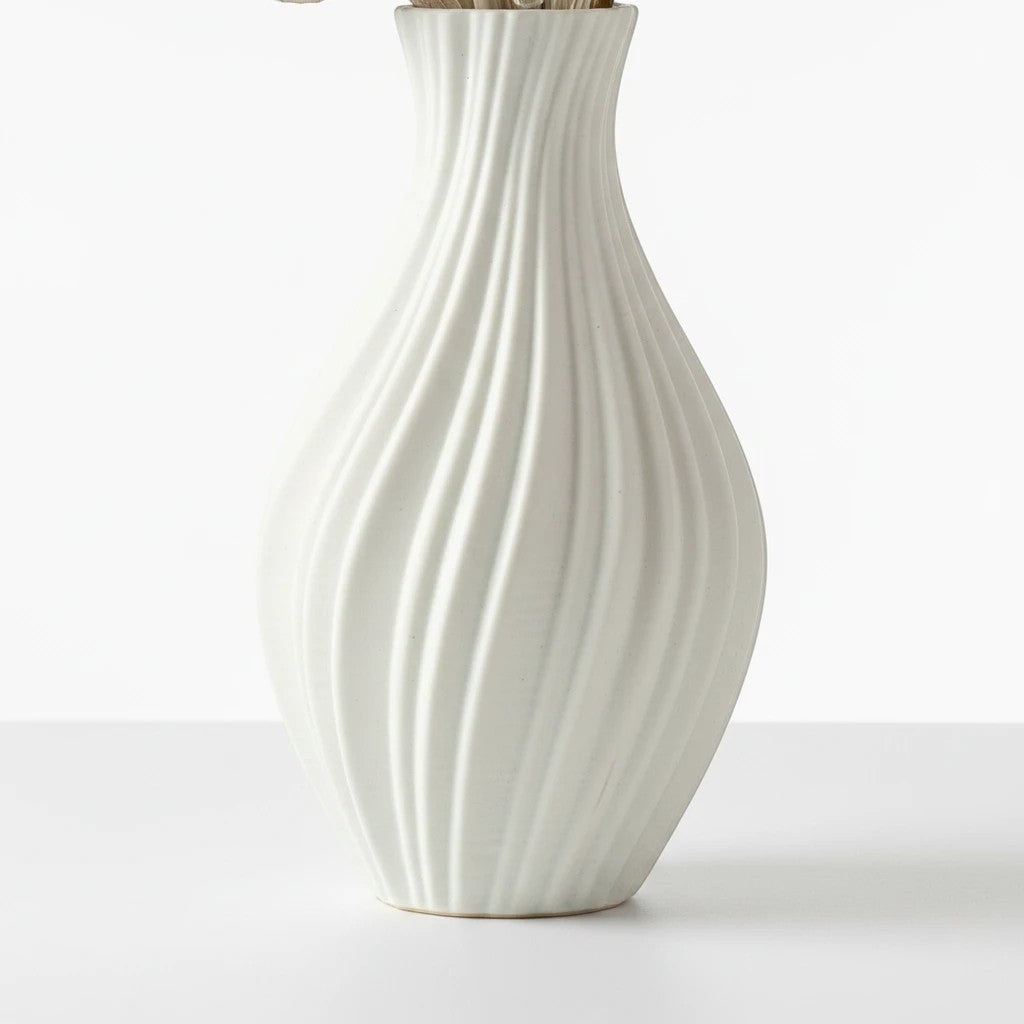 High Objects Lunara Vase, white ceramic with a flowing ribbed pattern and curved silhouette. Modern art accent.
