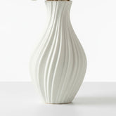 High Objects Lunara Vase, white ceramic with a flowing ribbed pattern and curved silhouette. Modern art accent.