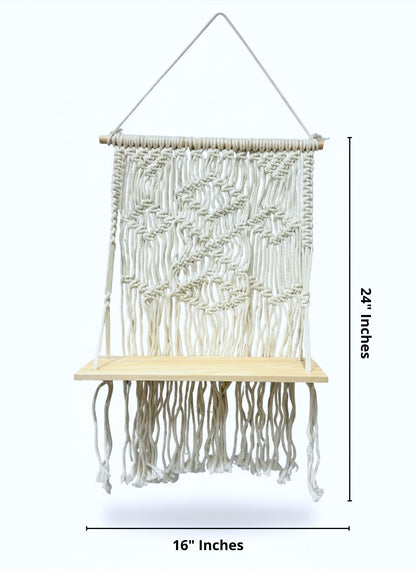 High Objects cream macramé shelf with diamond and chevron weaves, natural wood base, and hanging rope. 24" H x 16" W.