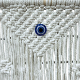 High Objects NazarGuard Boho Macrame Shelf with white cotton ropes and blue evil eye detail. Handmade wall decor.