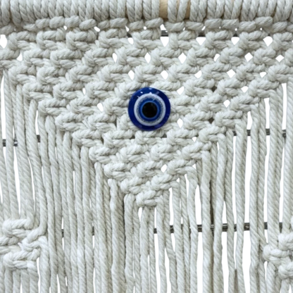 High Objects NazarGuard Boho Macrame Shelf with white cotton ropes and blue evil eye detail. Handmade wall decor.