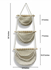 High Objects cream macrame wall hanging with three pockets and wooden dowels. Boho-style storage for plants or decor.