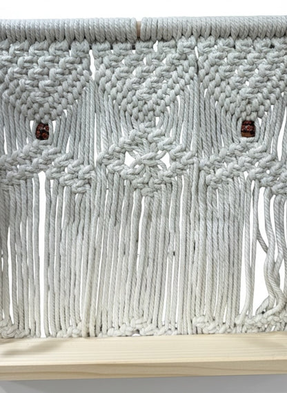 High Objects Ethereal Collection macrame wall shelf with wooden base, cream cotton rope, and decorative wooden beads.
