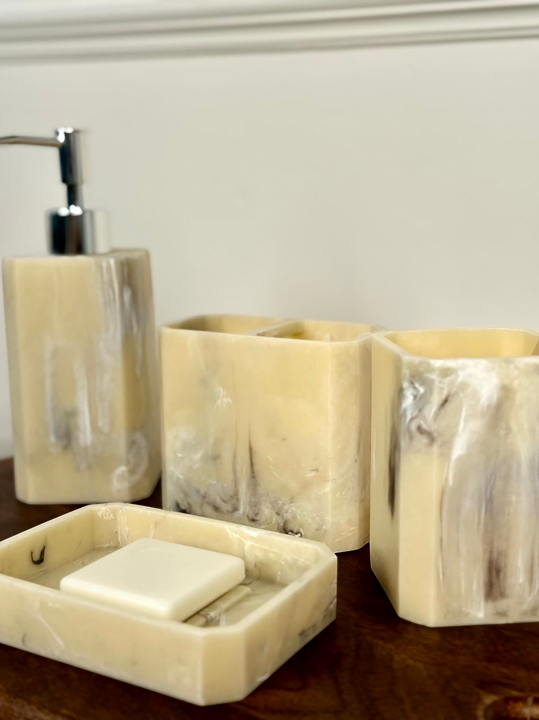 High Objects Marrow Stone Bathroom Accessory Set: lotion dispenser, soap dish, and two tumblers in marbled cream and grey.