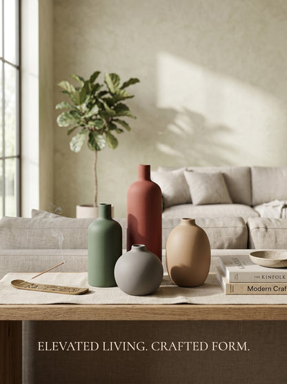 High Objects set of four matte ceramic vases in green, rust, grey, and tan. Various shapes and sizes.