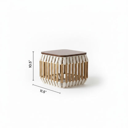 High Objects modern coffee table with woven base and wooden top, includes 4 stools. Neutral throw blanket draped on top.