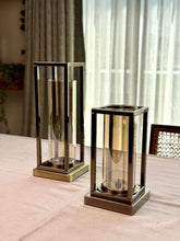 High Objects Modern Halo Frame Candle Stand Set, bronze metal rectangular frames with amber glass cylinders, set of two.