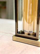 High Objects Modern Halo Frame candle stand set with amber glass cylinder and antique brass metal frame.
