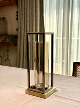 High Objects Modern Halo Frame candle stand set with rectangular metal frame and cylindrical glass chamber, antique brass finish.