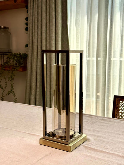 High Objects Modern Halo Frame candle stand set with rectangular metal frame and cylindrical glass chamber, antique brass finish.
