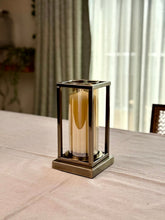High Objects Modern Halo Frame candle stand with amber glass cylinder and bronze metal frame, set of 3 heights.