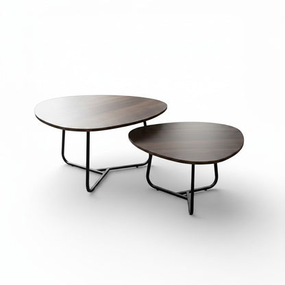 High Objects modern nesting coffee table set with dark wood tops and black metal bases. One table holds a plant, book, and mug.