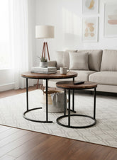 High Objects modern nesting coffee table set with round wooden tops and black metal frames. Two tables shown, one smaller nested under the larger.