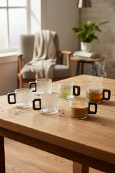 High Objects NEXIS glass cups with textured finish and square handles, set of 6. Some filled with coffee and tea.