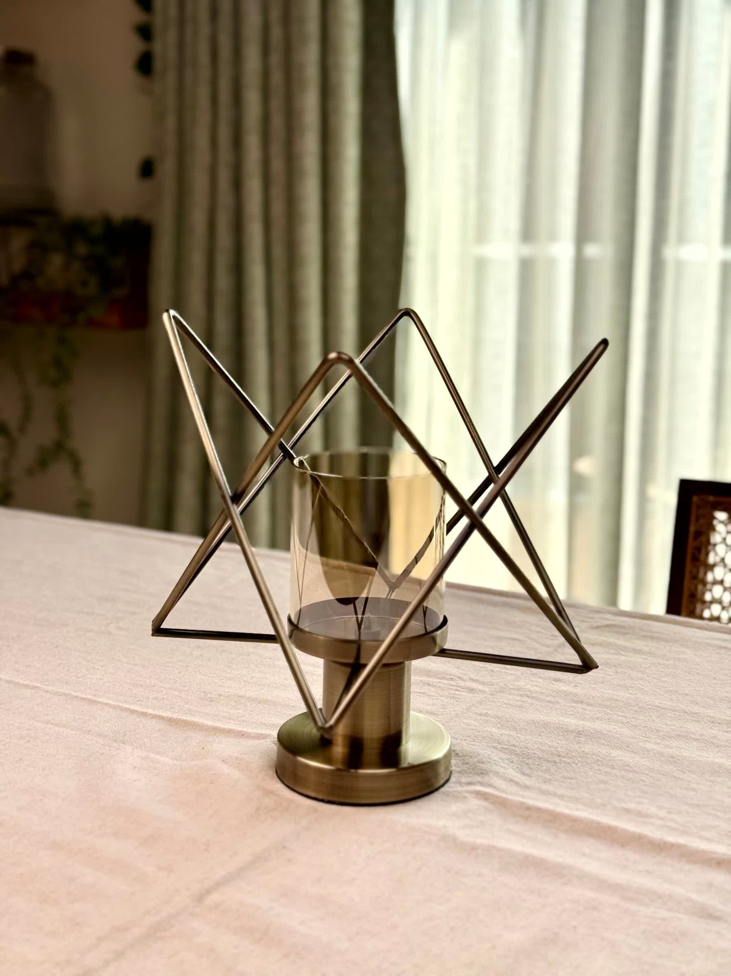 High Objects Nexus Geo Candle Stand with metallic pedestal and geometric wire frame. Bronze finish.