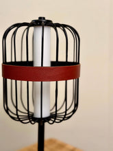 High Objects Noir Ember Cage Table Lamp with black wire cage, red leather band, and gold accents.