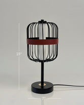 High Objects Noir Ember Cage Table Lamp with matte black wire cage, red leather accent, and gold base detail.