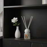 High Objects frosted glass reed diffuser with floral artwork and Ocean scent. Includes white reeds.