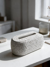 High Objects Olea white rectangular tissue box with a textured stone-like finish and rounded edges on a table.