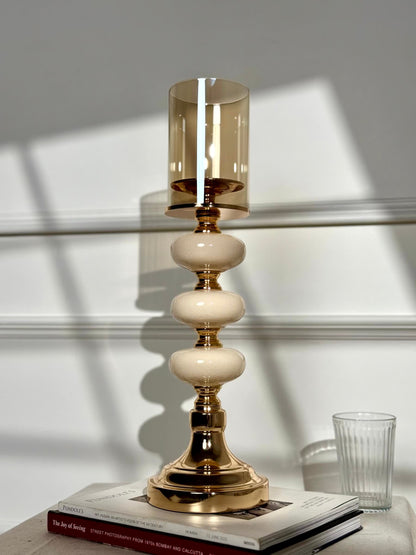 High Objects Opaline Gold Candle Stand Collection with amber glass hurricane shade and stacked opaline accents.