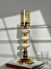 High Objects Opaline Gold Candle Stand Collection with amber glass hurricane shade and stacked opaline accents.