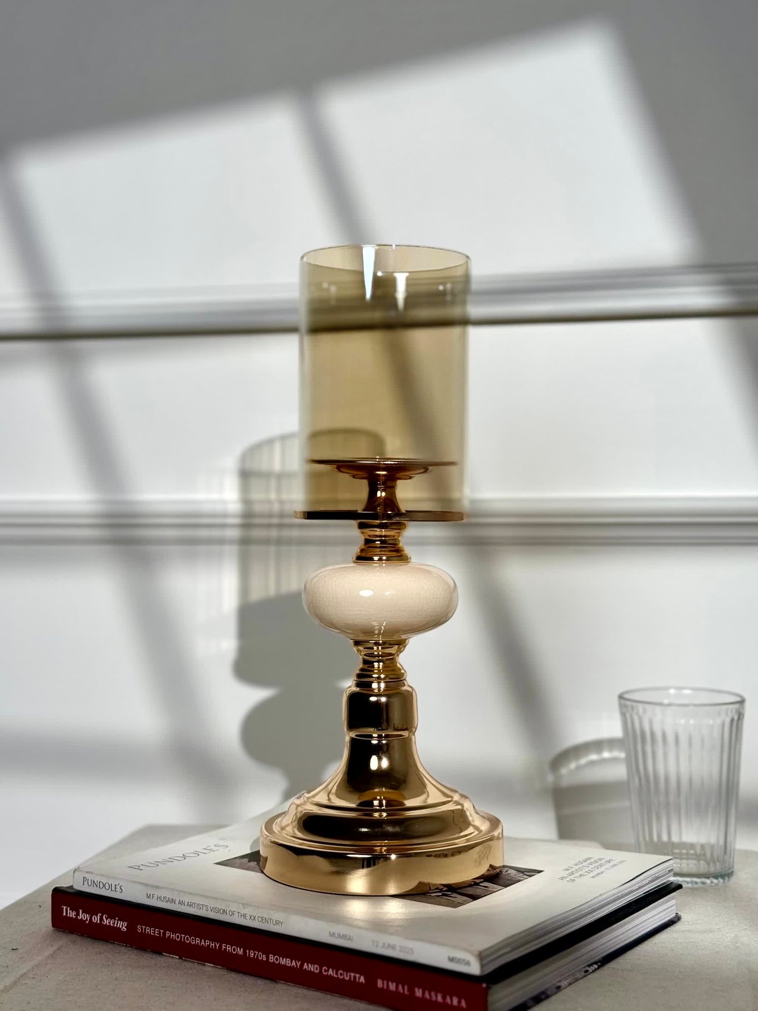High Objects Opaline Gold Candle Stand Collection with amber glass hurricane shade and opaline accent.
