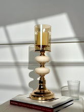 High Objects Opaline Gold Candle Stand Collection with amber glass hurricane shade and stacked opaline accents.