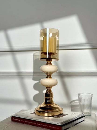 High Objects Opaline Gold Candle Stand Collection with amber glass hurricane shade and stacked opaline accents.