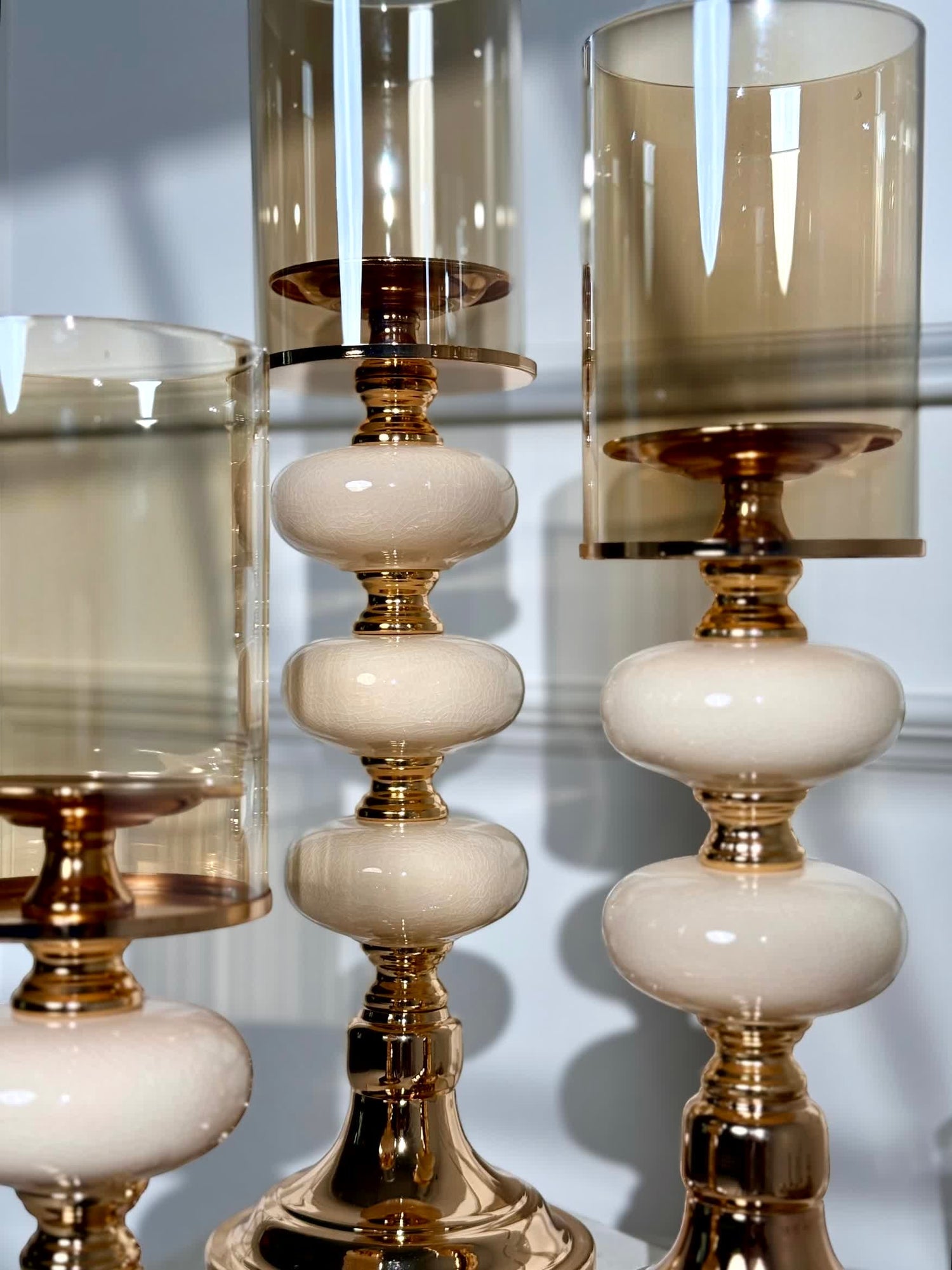 High Objects Opaline Gold Candle Stand Collection: Set of 3 gold candle holders with opaline accents and amber glass shades.