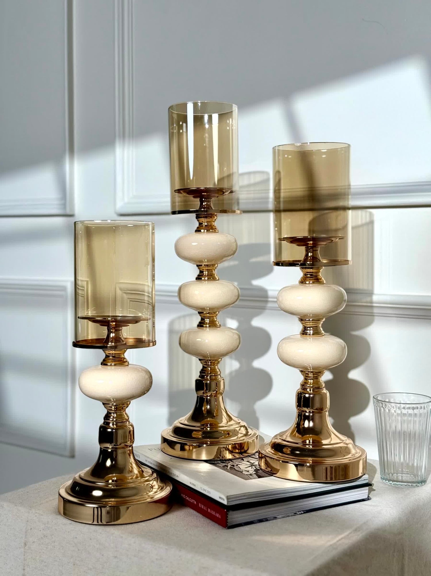 High Objects Opaline Gold Candle Stand Collection set of 3, featuring gold bases, opaline accents, and amber glass shades.