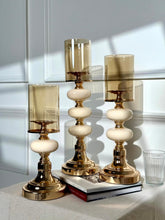 High Objects Opaline Gold Candle Stand Collection set of 3, featuring gold bases, opaline accents, and amber glass shades.