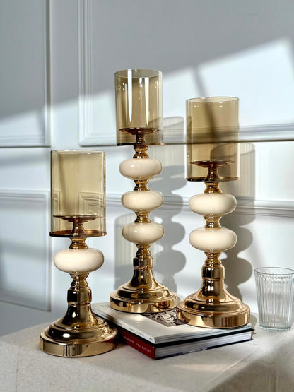 High Objects Opaline Gold Candle Stand Collection set of 3, featuring gold bases, opaline accents, and amber glass shades.