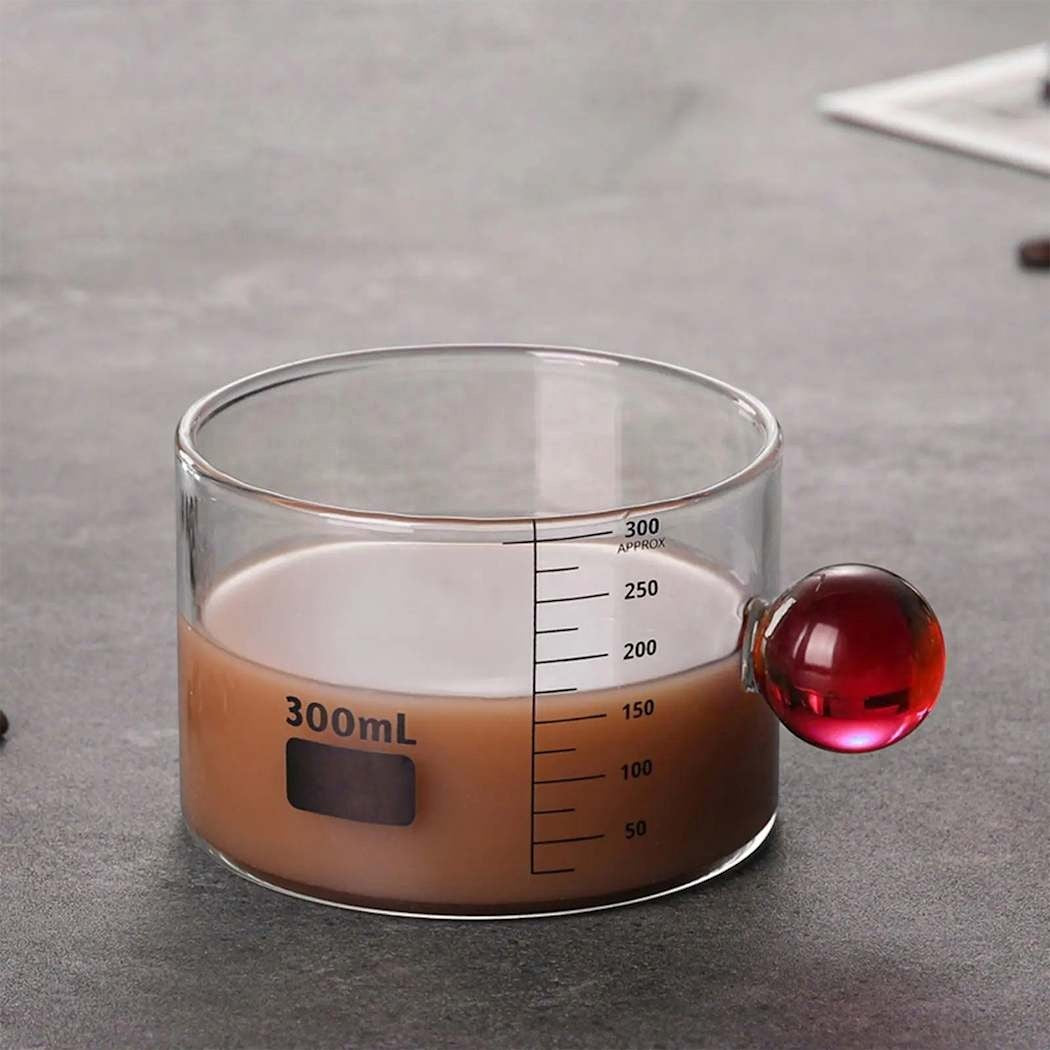 High Objects Orb Glass Cup with red orb handle, 300ml capacity, clear measurement markings, borosilicate glass