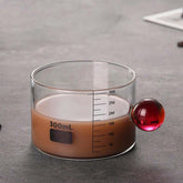 High Objects Orb Glass Cup with red orb handle, 300ml capacity, clear measurement markings, borosilicate glass