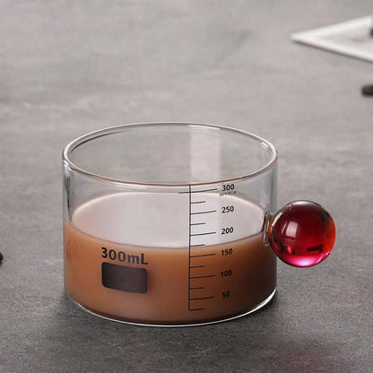 High Objects Orb Glass Cup with red orb handle, 300ml capacity, clear measurement markings, borosilicate glass