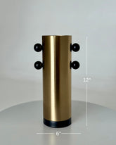 High Objects Orbis Luxe Vase: Cylindrical gold vase with black orb accents, 12" H x 6" W.
