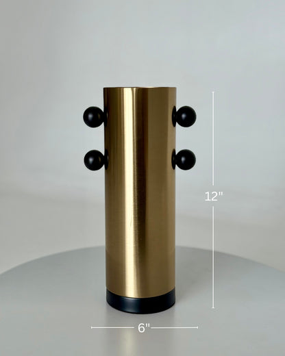 High Objects Orbis Luxe Vase: Cylindrical gold vase with black orb accents, 12" H x 6" W.