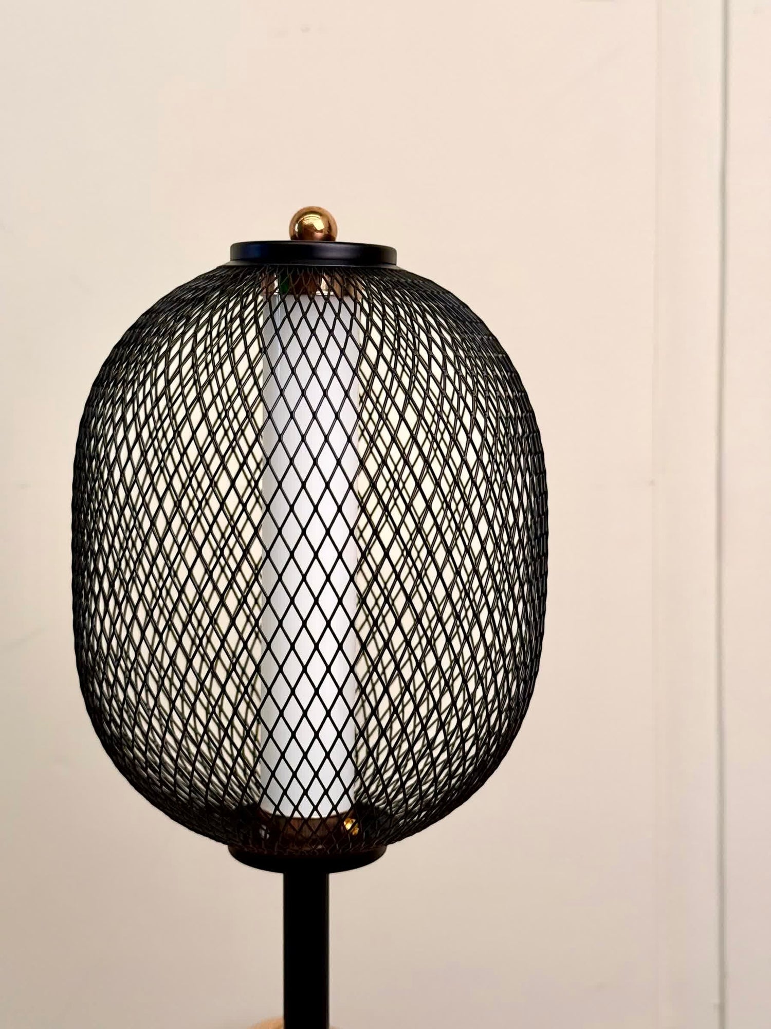 High Objects Orion black mesh pedestal table lamp with gold accent and white cylindrical shade.