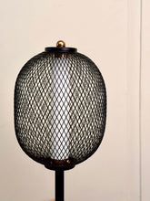 High Objects Orion black mesh pedestal table lamp with gold accent and white cylindrical shade.