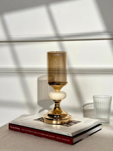 High Objects Pebble Luxe Candle Stand Set, gold metal with amber glass hurricane and textured stone accent.